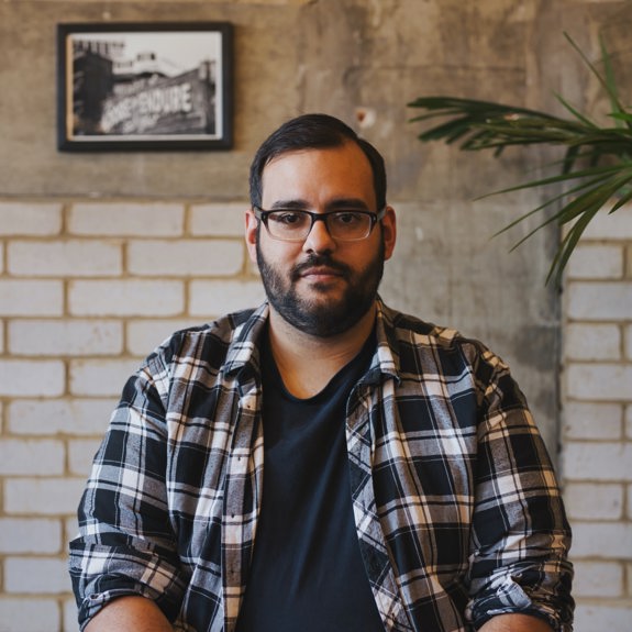 Man with glasses looking at the camera