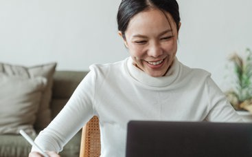 Woman smiling to her laptop