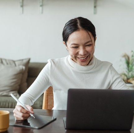 Woman smiling to her laptop