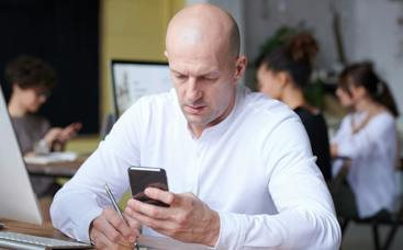 picture of man at desk on phone