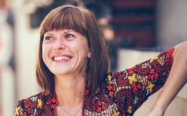 Woman smiling with red top