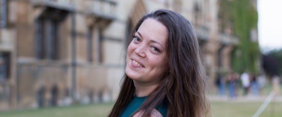 Woman smiling in front of university